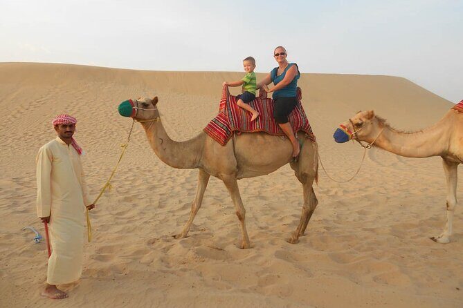 Dubai Experience: Quad bike, BBQ Dinner and Live Show - Camel riding and sand boarding: the camp fun that rounds out the night