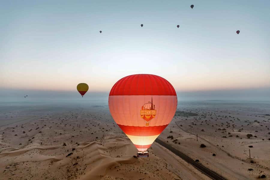 Dubai: Hot Air Balloon, Desert Safari, and Quad Biking Tour - Hot air balloon flight over the Dubai Desert Conservation Reserve at sunrise