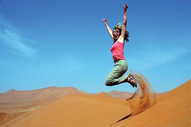 Dubai Red Dune Safari with BBQ Dinner and Live Shows - Sandboarding and sunset camel riding: time it for the best photos