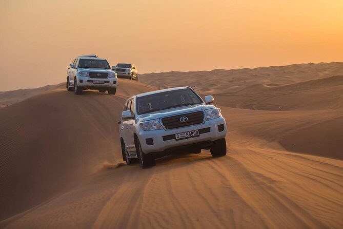 Dubai Red Dunes Desert Safari : Sandboarding, BBQ & Live Shows - Lahbab Red Dunes: Dune Bashing, Sandboarding, and a Sunset Camel Ride