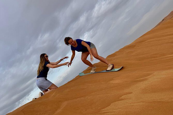Dubai Red Dunes Quad Bike Tour,Sandboard, Camel ride & BBQ Dinner - Sandboarding, Camels, Falcons, and Henna: your desert photo stops