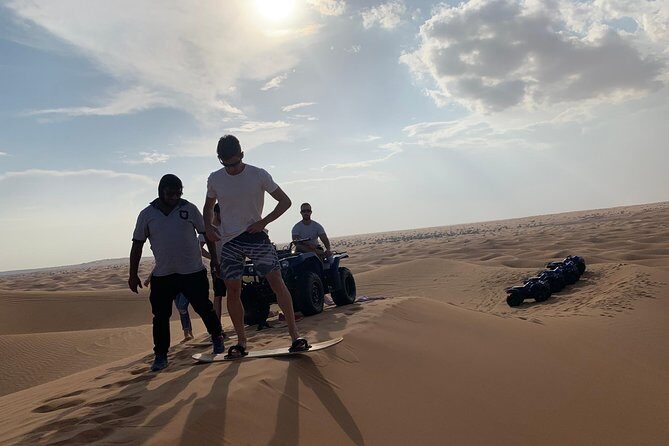 Dubai: Unique SUNSET Quad Bike Red Dunes Safari - Sandboarding at sunset: more fun than you expect