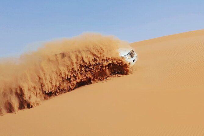Evening Desert Safari Dubai with BBQ Dinner & Shows - Into Al Madam: dune bashing, sandboarding, and a camel break