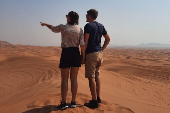 Evening Desert Safari in Dubai with Dune Bashing , Camel Ride and BBQ Dinner - Sandboarding at the dunes: the fun part with guidance