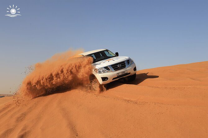 Morning Desert Safari in Dubai with Camel Ride - Sandboarding on red dunes: fun, fast, and a little messy