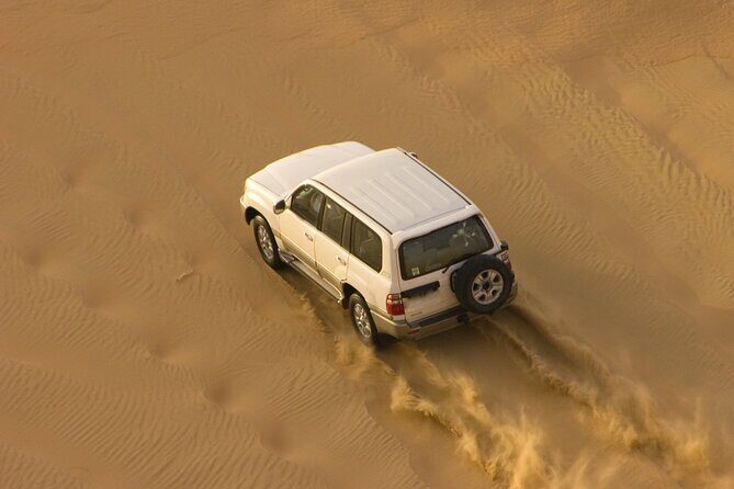 Morning Desert Safari plus Quad Bike, Sandboard and Camel ride - Quad bike driving through Dubai dunes
