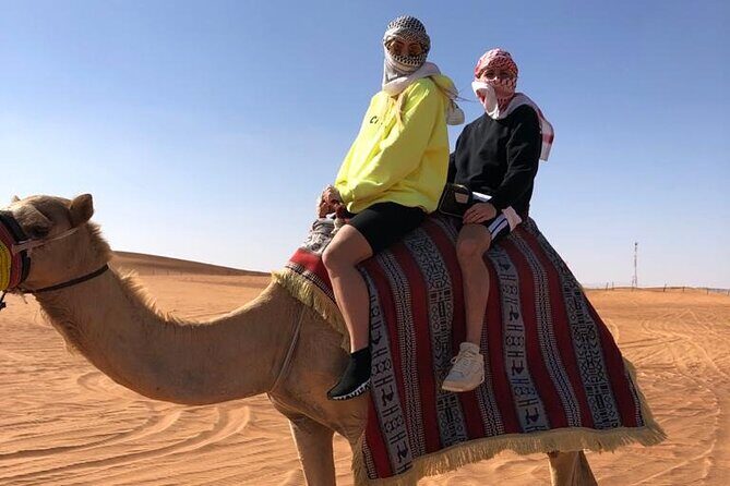 One hour Quad Bike at Red Sand Desert Safari with Camel Ride and BBQ Dinner - Camel ride, henna painting, and sandboarding: the calmer desert moments