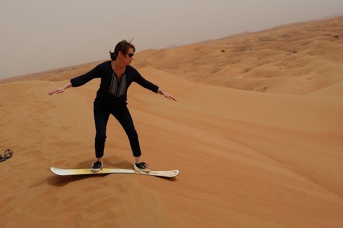 Private Desert Safari With Sand Boarding Quad bike and Camel Ride BBQ Dinner - Sand boarding from high dunes plus a short camel ride