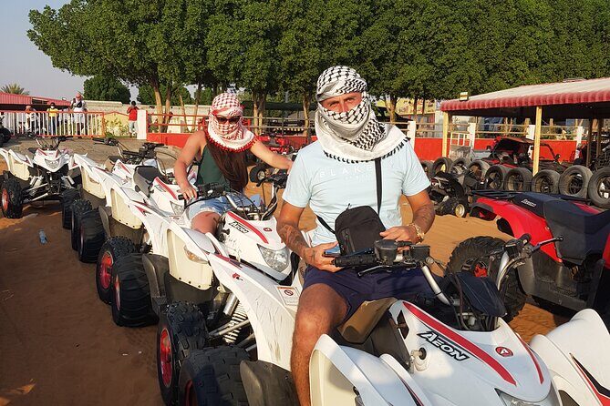 Sunrise Desert safari With Quad bike ride Sandboard & Camel ride - Sandboarding and the middle-of-desert photo stop