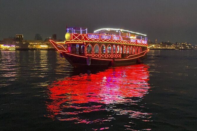 Witness the beauty of Dubai as you embark on traditional Dhow - Deck choice: air-conditioned comfort downstairs, open-air views up top